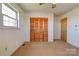 Bedroom featuring carpet, neutral walls, a window, and wood closet doors at 5830 W Nc 10 Hwy, Hickory, NC 28602