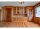 Classic dining room featuring hardwood flooring, built-in shelving, and paneled walls at 5830 W Nc 10 Hwy, Hickory, NC 28602