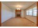 Open living room with neutral carpet, brick fireplace, and ample natural light at 5830 W Nc 10 Hwy, Hickory, NC 28602