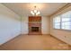 Bright living room showcasing a classic brick fireplace and neutral carpeting at 5830 W Nc 10 Hwy, Hickory, NC 28602