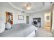 Bright bedroom showcases tray ceiling, ceiling fan, work space, and ensuite bath at 663 Sixth Baxter Xing, Fort Mill, SC 29708