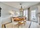 Elegant dining room with a wood table, stylish chandelier, and neutral decor creating a cozy space at 663 Sixth Baxter Xing, Fort Mill, SC 29708