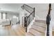 Inviting entryway with wood floors, staircase with iron railings, and decorative accents at 663 Sixth Baxter Xing, Fort Mill, SC 29708