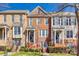 Charming brick townhomes with well-maintained landscaping and inviting front entrances on a sunny day at 663 Sixth Baxter Xing, Fort Mill, SC 29708