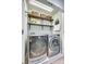 Efficient laundry room with modern LG washer and dryer, storage shelves, and a skylight for natural light at 663 Sixth Baxter Xing, Fort Mill, SC 29708