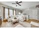 Airy living room featuring a ceiling fan, natural light, and a comfortable white sectional sofa at 663 Sixth Baxter Xing, Fort Mill, SC 29708