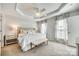 Bright main bedroom features a tray ceiling, neutral decor, and large windows at 663 Sixth Baxter Xing, Fort Mill, SC 29708