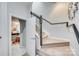 Carpeted staircase with black handrail leads to upper level, showcasing an inviting entryway and stylish decor at 663 Sixth Baxter Xing, Fort Mill, SC 29708