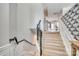 Carpeted staircase with decorative black railing and white trim, leading up to the second floor at 663 Sixth Baxter Xing, Fort Mill, SC 29708