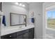 Bright bathroom features a vanity with a large mirror and natural light at 664 Bluff Loop Rd # 202, Rock Hill, SC 29730