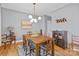 Bright dining area features a hardwood floor, statement lighting fixture and an adjacent wine hutch at 664 Bluff Loop Rd # 202, Rock Hill, SC 29730