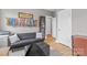 A home office and lounge area showcasing a gray wall with medals, a desk, and a modern black couch at 664 Bluff Loop Rd # 202, Rock Hill, SC 29730