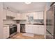 Well-lit kitchen boasting stainless steel appliances, granite countertops, and ample cabinet space at 7101 Quail Meadow Ln, Charlotte, NC 28210