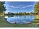 Scenic lake view with reflections of trees and sky, bordered by lush greenery at 7101 Quail Meadow Ln, Charlotte, NC 28210