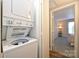 Laundry area with stacked washer and dryer, leading to a comfortable and well-lit bedroom at 7101 Quail Meadow Ln, Charlotte, NC 28210