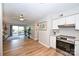 Bright living room open to kitchen features wood floors and sliding doors to the patio at 7101 Quail Meadow Ln, Charlotte, NC 28210