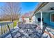 Inviting back porch area, great for outdoor dining with a grill, table and chairs at 723 W Zion Church Rd, Shelby, NC 28150