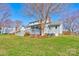 Beautiful backyard featuring a deck, lush green grass, and mature trees at 723 W Zion Church Rd, Shelby, NC 28150