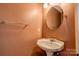 A bathroom with a pedestal sink, mirror, and towel bar at 723 W Zion Church Rd, Shelby, NC 28150