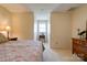 Neutral bedroom featuring patterned bedspread, decorative wall art, and a small window at 723 W Zion Church Rd, Shelby, NC 28150