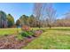 View of flower bed and yard leading into the home and wooded area at 723 W Zion Church Rd, Shelby, NC 28150