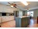 Bright kitchen boasts white cabinets, granite countertops, stainless steel appliances, and a center island with seating at 723 W Zion Church Rd, Shelby, NC 28150