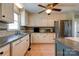 A kitchen with tile backsplash, light cabinets, stainless refrigerator, and tile flooring at 723 W Zion Church Rd, Shelby, NC 28150