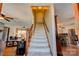 Carpeted staircase with wooden banister leading to the upper level, adjacent to the living and kitchen areas at 723 W Zion Church Rd, Shelby, NC 28150