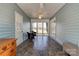 Bright sunroom featuring wood-paneled walls, windows overlooking the yard, and a cozy seating area at 723 W Zion Church Rd, Shelby, NC 28150