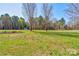 View of the grassy yard leading into the wooded area of the property at 723 W Zion Church Rd, Shelby, NC 28150