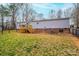 The spacious backyard features a deck, lawn, and a chain-link fence at 80 Sunset Dr, Taylorsville, NC 28681