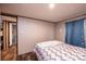 Neutral bedroom featuring wood floors, a bed, and minimalist decor at 80 Sunset Dr, Taylorsville, NC 28681