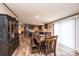 Dining room with a dark wood table, benches, and cabinetry, adjacent to the kitchen at 80 Sunset Dr, Taylorsville, NC 28681