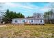 Charming single-story home features a wooden porch, well-maintained lawn, and picturesque landscaping at 80 Sunset Dr, Taylorsville, NC 28681