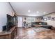 Spacious living room featuring a large sectional sofa and wood-look flooring at 80 Sunset Dr, Taylorsville, NC 28681