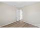 Bright bedroom with neutral walls and light color wood flooring throughout the room at 8009 Idlewild Rd, Indian Trail, NC 28079