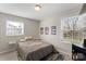 Comfortable bedroom featuring neutral paint, wood-look floors and lots of natural light at 8009 Idlewild Rd, Indian Trail, NC 28079