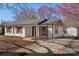 Charming, remodeled single-story home featuring brick facade, wooden shutters, a fenced yard, and a shed at 8009 Idlewild Rd, Indian Trail, NC 28079