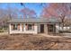 Charming, remodeled single-story home featuring brick facade, wooden shutters, and a well-manicured front yard at 8009 Idlewild Rd, Indian Trail, NC 28079