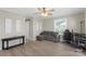 Bright living room with neutral walls, modern ceiling fan, and barn door at 8009 Idlewild Rd, Indian Trail, NC 28079