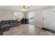 Inviting living room featuring wood-look floors, neutral paint, a ceiling fan and lots of natural light at 8009 Idlewild Rd, Indian Trail, NC 28079