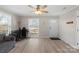 Inviting living room featuring wood-look floors, neutral paint, a ceiling fan and lots of natural light at 8009 Idlewild Rd, Indian Trail, NC 28079