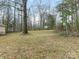 Large backyard with several mature trees at 8101 Coxwood Ct, Charlotte, NC 28227