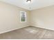 A sunlit bedroom is carpeted and features a window with natural light at 8101 Coxwood Ct, Charlotte, NC 28227