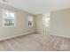 A spacious carpeted bedroom features natural light from the two windows at 8101 Coxwood Ct, Charlotte, NC 28227