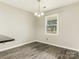 Bright dining area with stylish wood floors and a modern chandelier fixture at 8101 Coxwood Ct, Charlotte, NC 28227