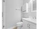 Clean, minimalist bathroom with white vanity, toilet, and modern fixtures at 8328 Highland Glen Dr, Charlotte, NC 28269