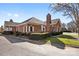 Charming brick home featuring manicured landscaping, a cozy patio, and a classic chimney at 8328 Highland Glen Dr, Charlotte, NC 28269