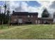 Back exterior of home with brick and a rear deck visible in a well-maintained yard at 8432 Junction Ct, Charlotte, NC 28215