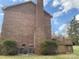 Brick home featuring a back deck and chimney, perfect for outdoor entertaining at 8432 Junction Ct, Charlotte, NC 28215